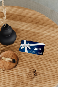 Stellies gift card on a wooden surface